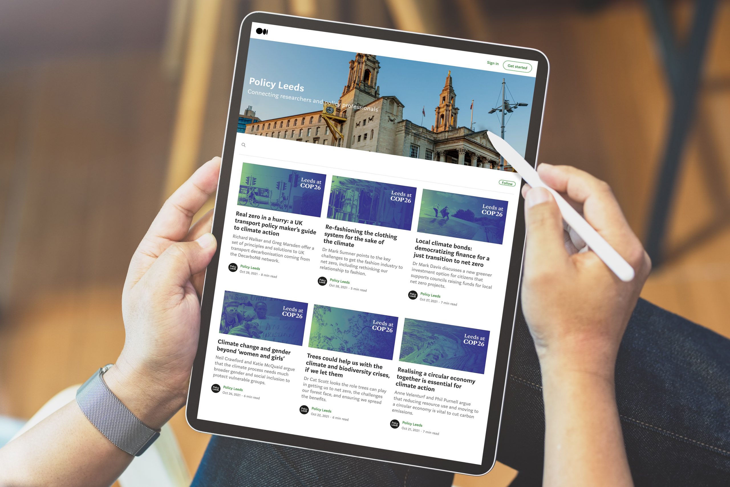 Leeds at COP26 policy homepage person holding iPad